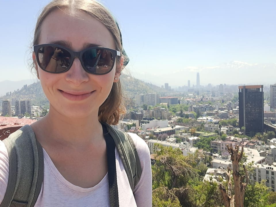 anja on a mountain with santiago de chile in the background
